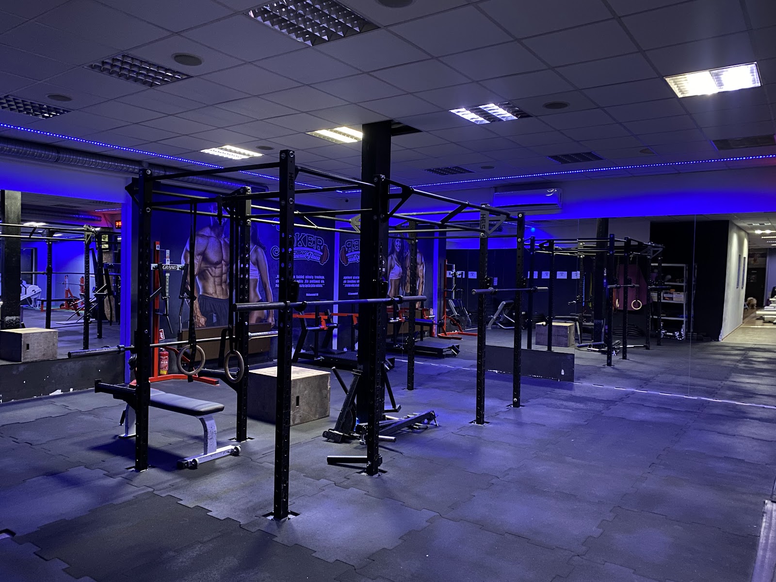 Blue-lit functional training zone at Joker Leszno